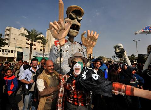 Egyptian protesters hold an effigy depicting President Mohamed Mursi while shouting slogans during an anti-government demonstration in the canal city of Port Said last Friday (AFP Photo / Stringer)