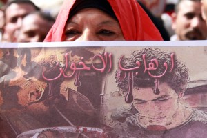 A woman demonstrates in Tahrir square, 1 March, holding a placard saying: "The Terrorism of the Brotherhood" (Mohamed Omar/DNE)