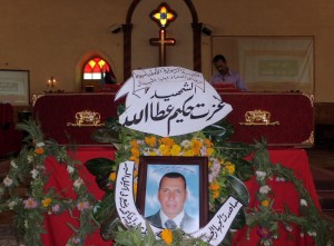 The coffin of Ezzat Hakim Attallah (portrait), who died in the eastern Libyan city of Benghazi, days after being arrested on charge for allegedly seeking to convert Muslims in Libya, is seen during his funeral service at a church in Assiut city (AFP Photo)