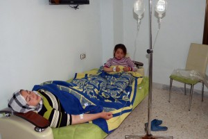 In this image made available by the Syrian News Agency (SANA) a woman and a girl rest on a mattress at a hospital in the Khan al-Assal region in the northern Aleppo province, as Syria's government accused rebel forces of using chemical weapons for the first time. (AFP Photo)