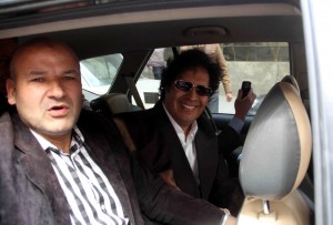 Ahmed Kadhaf al-Damm (C), cousin of ousted Libyan leader Moamer Kadhafi, smiles as he is escorted by Egyptian policemen in a car after being arrested in Cairo (AFP Photo\ Stringer)