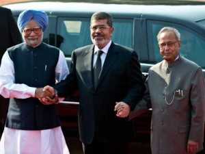 President Morsi meets with Indian Prime Minister Manmohan Singh (left) and India President Pranab Mukherjee (right) as he arrives in Delhi. Morsi told newspaper The Hindu that he hoped the BRICS bloc would become the ‘E-BRICS’ bloc once Egypt got its economy back on track (AFP Photo) 