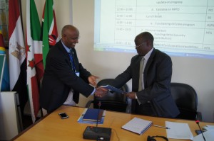Mugisha Shillingi (right), from Uganda’s Ministry of Water and Environment, hands over the NCORE Project Appraisal Document to The Executive Director of the NBI Secretariat Teferra Beyene, soon after the project’s launch  (Photo Courtesy of the NBI) 
