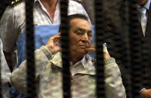 Ousted Egyptian president Hosni Mubarak sits behind bars during his retrial at the Police Academy in Cairo on April 15, 2013.  (AFP File Photo / Maher Iskander) 