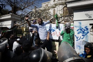 gyptian riot policemen try to prevent Egyptian protesters from leaving a Syrian opposition flag on the gate of the Iranian ambassador's residence in Cairo on April 5, 2013 during a demonstration organised by Salafists to protest against Iranian tourists visiting Egypt and any political and diplomatic relations between Iran and Egypt (AFP Photo)