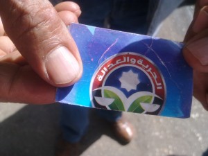 One protester brandishing a sticker (above) accused the minister of supply Bassem Ouda of ordering the fixing of stickers labelled with the Muslim Brotherhood logo onto gas cylinders during the parliamentary elections (Hend El-Behary/DNE Photo) 