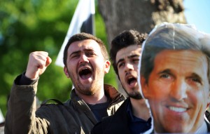 Turkish nationalist students chant slogans as they hold a picture of US Secretary of State John Kerry during a demonstration against his visit at the Friends of Syria meeting on April 20, 2013 in front the meeting area on Uskudar in Istanbul.(AFP Photo)