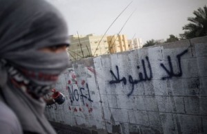 A Bahraini protester writes graffiti against the Bahrain Formula One Grand Prix in Jid Ali village, April 17, 2013. (AFP, Mohammed al-Shaikh) 