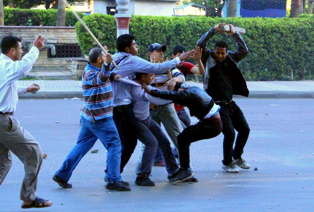 Members of the Muslim Brotherhood seize an opposing protester during clashes in Alexandria (Photo By: Ahmed Arab)