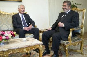 US Secretary of Defense Chuck Hagel (L) speaks with Egypt's President Mohamed Morsi at the Presidential Palace in Cairo on April 24, 2013. Hagel landed in Egypt as part of a Middle East tour designed to bolster America's alliances amid growing concern over the fallout from Syria's roiling civil war. (AFP Photo/POOL/JIM WATSON) 