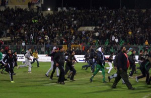 Egyptians football fans rush to the fiels during clashes that erupted after a football match between Egypt's Al-Ahly and Al-Masry teams in Port Said, 220 kms northeast of Cairo, on February 1, 2012.  (AFP File Photo)