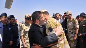 President Morsi with one of the freed soldiers (Presidency handout photo)
