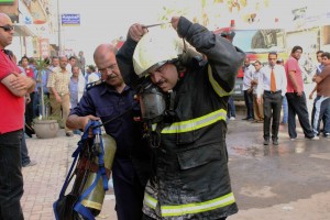 Fire-fighters help put out a fire at a hospital complex in Alexandria (Photo by: Ahmed Arab ) 