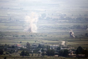A picture taken from the Israeli annexed Golan Heights shows smoke rising following explosions in a Syrian village near the Israeli border on May 7, 2013.  (AFP Photo)