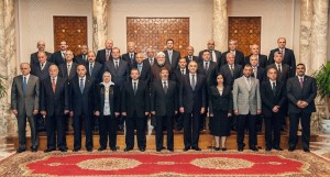 A handout picture released by the Egyptian presidency on May 7, 2013, shows Egypt's President Mohamed Morsi (C) posing for a group photograph with his Prime Minister Hisham Qandil (5th-L) and nine new ministers during a meeting in Cairo. Morsi appointed nine new ministers in a cabinet reshuffle in a shake-up that falls short of opposition demands. (AFP PHOTO / HO / EGYPTIAN PRESIDENCY)