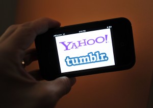 This May 19, 2013 photo illustration taken in Washington, DC, shows the splash page for Yahoo and blogging platformTumbler seen on an iPhone.  (AFP Photo)