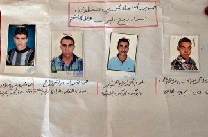 A picture shows the portraits and names of four out of seven Egyptian security forces kidnapped by gunmen in the Sinai during a demonstration calling for their release near the gate of the Rafah crossing border between Egypt and the Gaza Strip on May 20, 2013.  (AFP Photo)