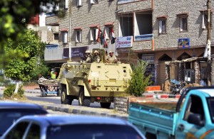 An Egyptian military armoured personnel carrier patrols a street in the Sheikh Zowied town near Rafah, in the northern Sinai on May 20, 2013. (AFP Photo)