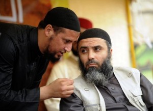Tunisia's fugitive Salafist leader Abu Iyadh (R) listens to an aide during a meeting on May 20, 2012 in Kairouan. Supporters of Iyadh (AFP File Photo)