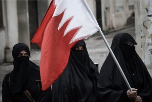 A Bahraini woman holds her national flag during an anti-government protest in solidarity with jailed political activist, Hisham Al-Sabbagh on April 30, 2013. (AFP Photo/Mohammed Al-Shaikh)