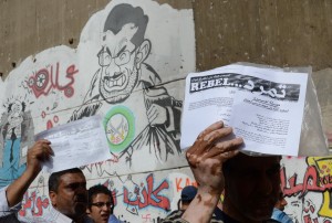 The Tamarod campaign plans to file a lawsuit accusing President Mohamed Morsi of “criminal impersonation” of the president as soon as they collect 15 million signatures. (DNE File Photo)