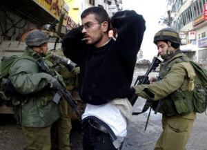 Israeli soldiers arrest a Palestinian man on March 30, 2002, in Ramallah following an all-night street battle (AFP/File, Andre Durand) 