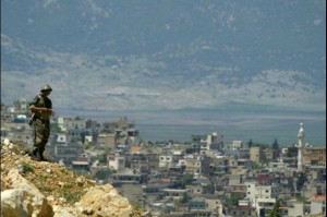 A Syrian soldier stands on a hill on the Syrian-Lebanese border. (AFP File Photo)