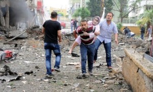Residents evacuate a wounded woman to hospital after car bombs exploded on May 11, 2013 in Reyhanli, Turkey (Anadolu Agency/AFP, Cem Genco) 